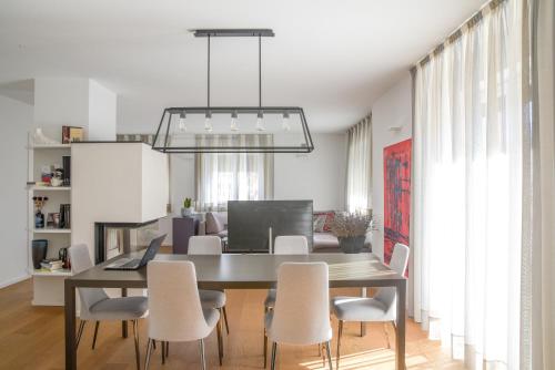a dining room with a table and chairs at Casa Riccardo in Levico Terme