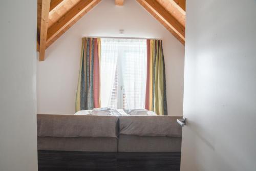 a room with a bed and a window at Casa Riccardo in Levico Terme