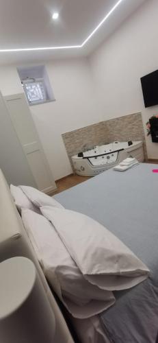 a bedroom with a bed with pillows and a window at Vient' e mar suite in Castellammare di Stabia