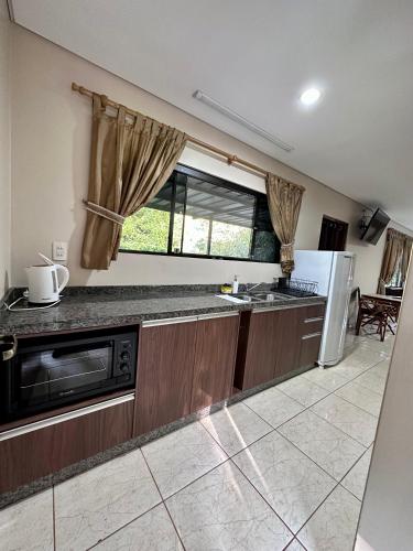 a kitchen with a sink and a dishwasher at Parque Hotel Manantial in Hohenau