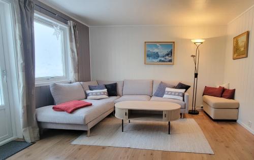 a living room with a couch and a table at Vacation Home in Fjordgård with views of Segla and the Fjord in Fjordgård