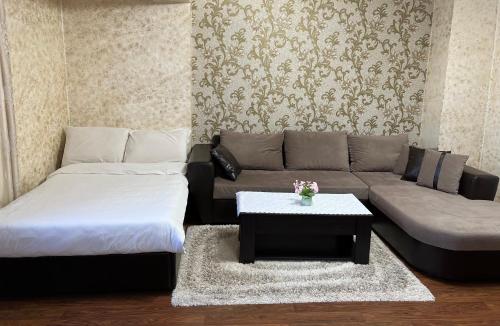a living room with a couch and a coffee table at Къща за гости Шарон in Petrich
