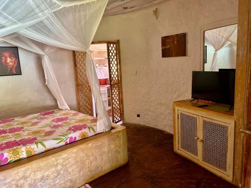Säng eller sängar i ett rum på Peponi Villa Malindi