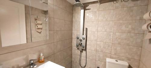 a bathroom with a shower with a toilet and a sink at Apollo 2 - Luxury Apartment in Katerini
