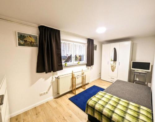 a bedroom with a bed and a window at Ferienwohnung Lena in Schwerin- Wickendorf in Schwerin