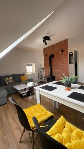 a living room with a couch and a table at Apartament Loft in Elblag