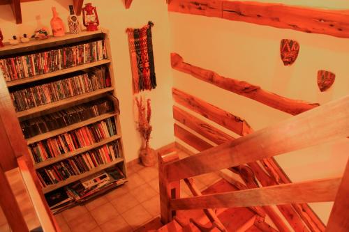 a room with a book shelf filled with dvds at Hosteria Al Paraiso in Villa Pehuenia