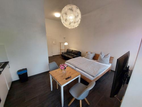 a bedroom with a bed and a table and a couch at Apartments im Mardefeldpalais in Ansbach
