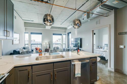 a kitchen with a sink and a living room at Sable 85 - Two Bedroom in Minneapolis