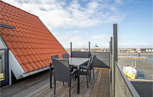 a table and chairs on the deck of a boat at Nice Apartment In Hemmet With Wifi in Hemmet