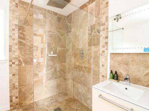 a bathroom with a shower and a sink at Lurach House in Port Appin