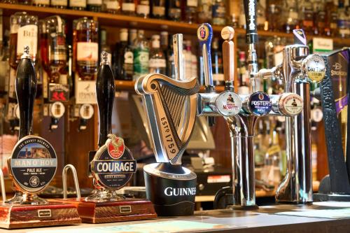 a bar with a harp on the counter of a pub at Ulbster Arms Hotel near Thurso in Halkirk