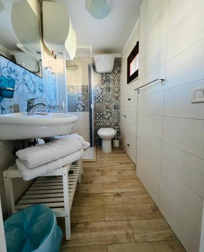 a bathroom with a sink and a toilet at B&B Stellamarina in Pulsano