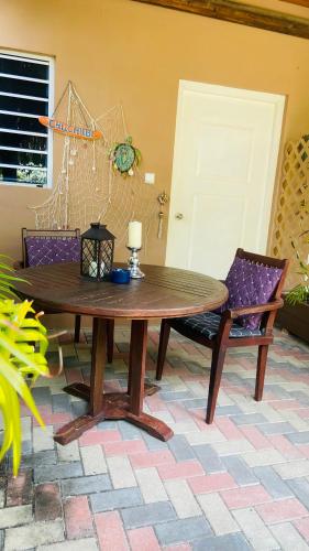 a wooden table and chairs in a room at Villa Unique in Willemstad