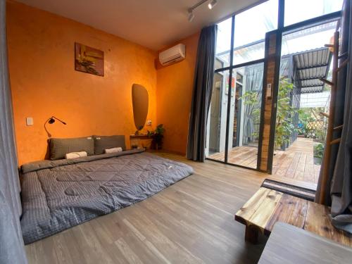 a bedroom with a bed and a large window at Trầm Homestay in Thôn An Hòa