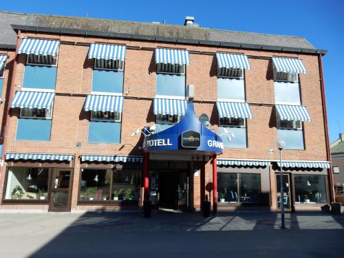 a large brick building with a hotel sign on it at Grand Hotell Bollnäs in Bollnäs