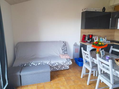 a small room with a bed and a table and chairs at Appartement d'une chambre avec vue sur le lac terrasse amenagee et wifi a Sainte Croix du Verdon a 2 km de la plage in Sainte-Croix-de-Verdon