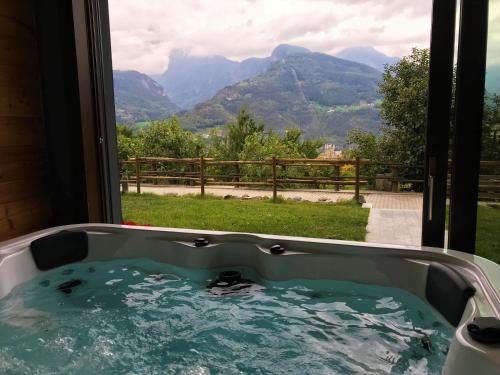 a bath tub with a view of a mountain at Affittacamere Verger Plein Soleil in Saint-Pierre