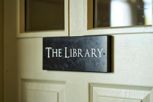 a sign on a door that reads the library at Ulbster Arms Hotel near Thurso in Halkirk