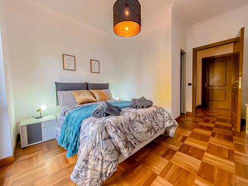 a bedroom with a bed and a wooden floor at [Piramide] Luxury Suite Colosseum in Rome