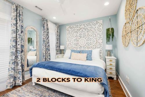 a bedroom with a blue and white bed with a mirror at Private Balcony 2 Living Rooms 2 Blocks to King in Charleston