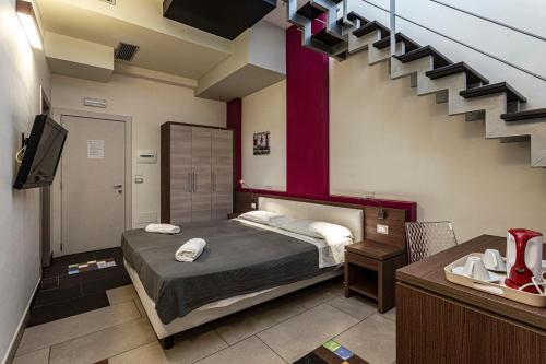 A bed or beds in a room at Hotel Don Giovanni