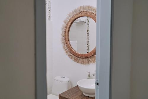 a bathroom with a mirror and a sink at El Bosque Hotel Boutique in Doradal