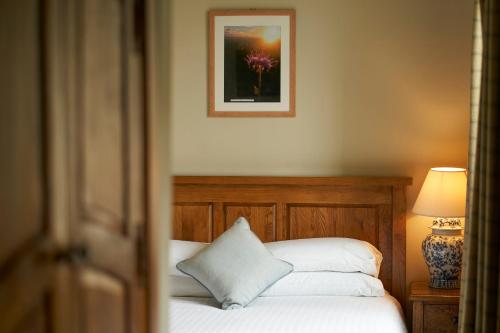 a bedroom with a bed and a picture on the wall at Ulbster Arms Hotel near Thurso in Halkirk
