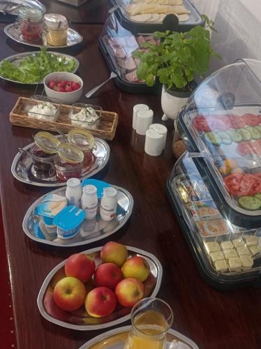 a table with many plates of food on it at Villa Zdrojowa in Otmuchów
