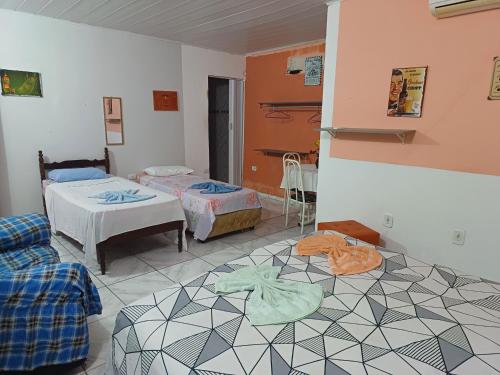 a room with two beds and a room with two beds at Pousada Lucrezia in Maceió