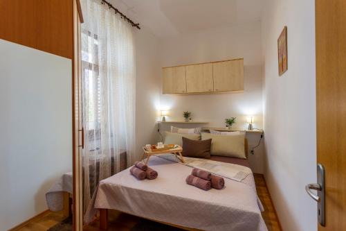 a bedroom with a bed with two teddy bears on it at Apartman LeMa in Pula