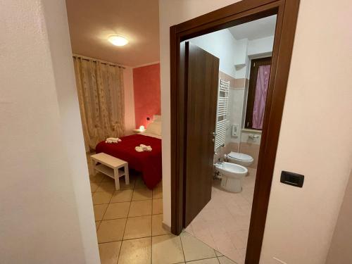 a small bathroom with a bed and a toilet at Il Casale Della Fornace in Bastia Umbra