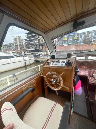 a boat with a stove in the back of it at Süsses Motorboot - Bremen Überseestadt in Bremen