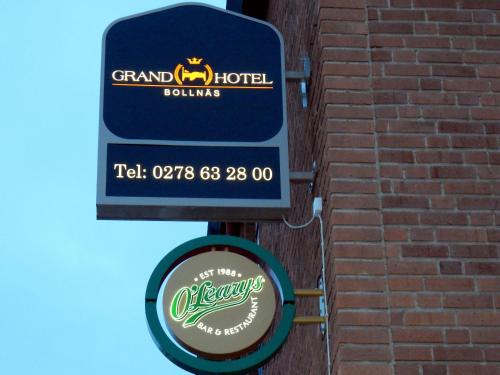 a sign for a grand hotel on a brick wall at Grand Hotell Bollnäs in Bollnäs