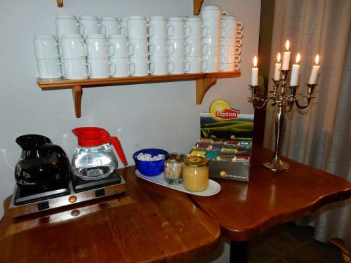a wooden table with a coffee maker and candles on it at Grand Hotell Bollnäs in Bollnäs