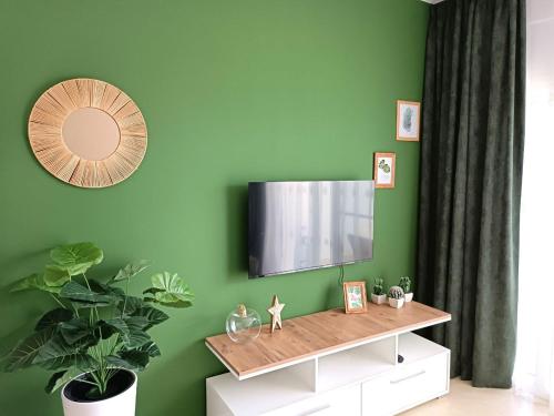 a living room with a television on a green wall at Northern Cyprus Trikomo, Iskele, Long Beach, Caesar Resort 2 in İskele