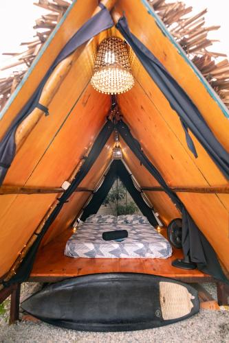 a tent with a dog bed inside of it at Back to the Beach Hostel - Pipa in Pipa