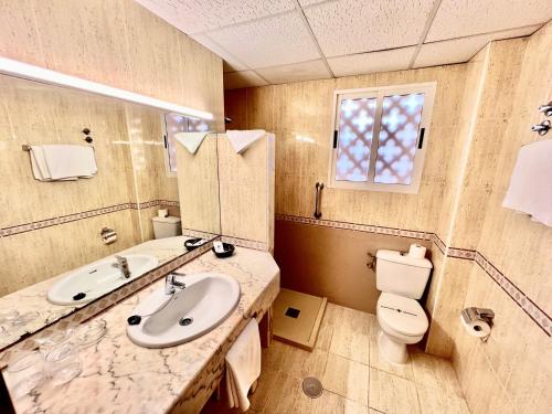 a bathroom with a sink and a toilet at Hotel Nadal in Benidorm
