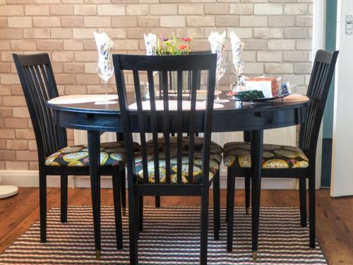 a black dining room table with two chairs and a blue table at Seal Parrock in Weathercote