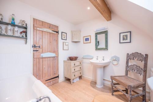 a bathroom with a sink and a toilet at Church Farm House Campsea Ashe in Woodbridge