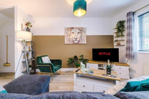 a living room with a tv and a couch at Spacious 3-Bed house in Chester by 53 Degrees Property, Ideal for Families & Professionals, FREE Parking - Sleeps 7 in Chester