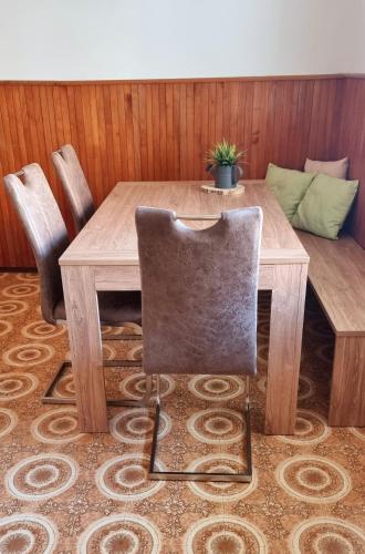 a wooden table with a chair in a room at Apartma Metka Bovec in Bovec