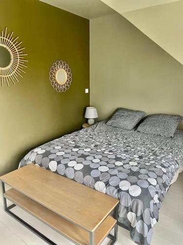 une chambre avec un grand lit et une table dans l'établissement Maison proche plages., à Benerville-sur-Mer