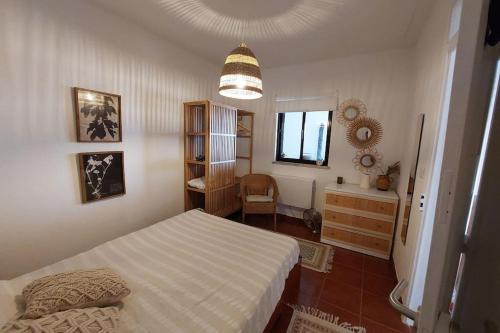 a bedroom with a bed and a dresser and a mirror at Casa do Vale in Vale de Água