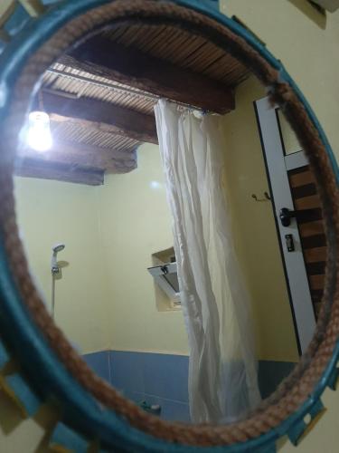 a mirror in a room with a door with a curtain at Hike and Chill Homestay in Tinerhir