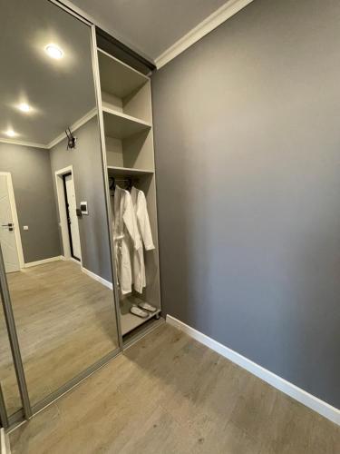 a walk in closet with a large mirror at Уютная квартира в новом ЖК Улытау in Karagandy