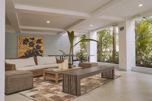 a living room with a couch and a table at El Bosque Hotel Boutique in Doradal