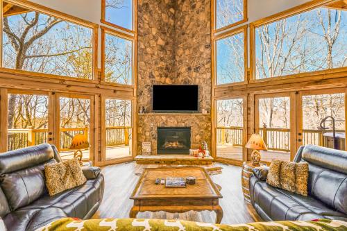 a living room with two couches and a fireplace at Cabina di Christina in Dahlonega