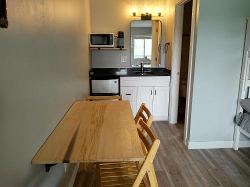 a kitchen with a wooden table and a microwave at Shafer Lakeside Resort in Monticello