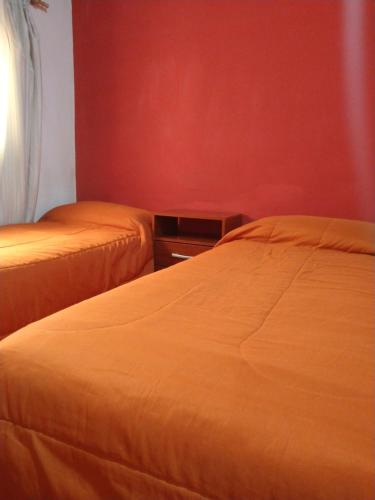 two beds sitting next to each other in a room at Dulce Hogar in Maimará
